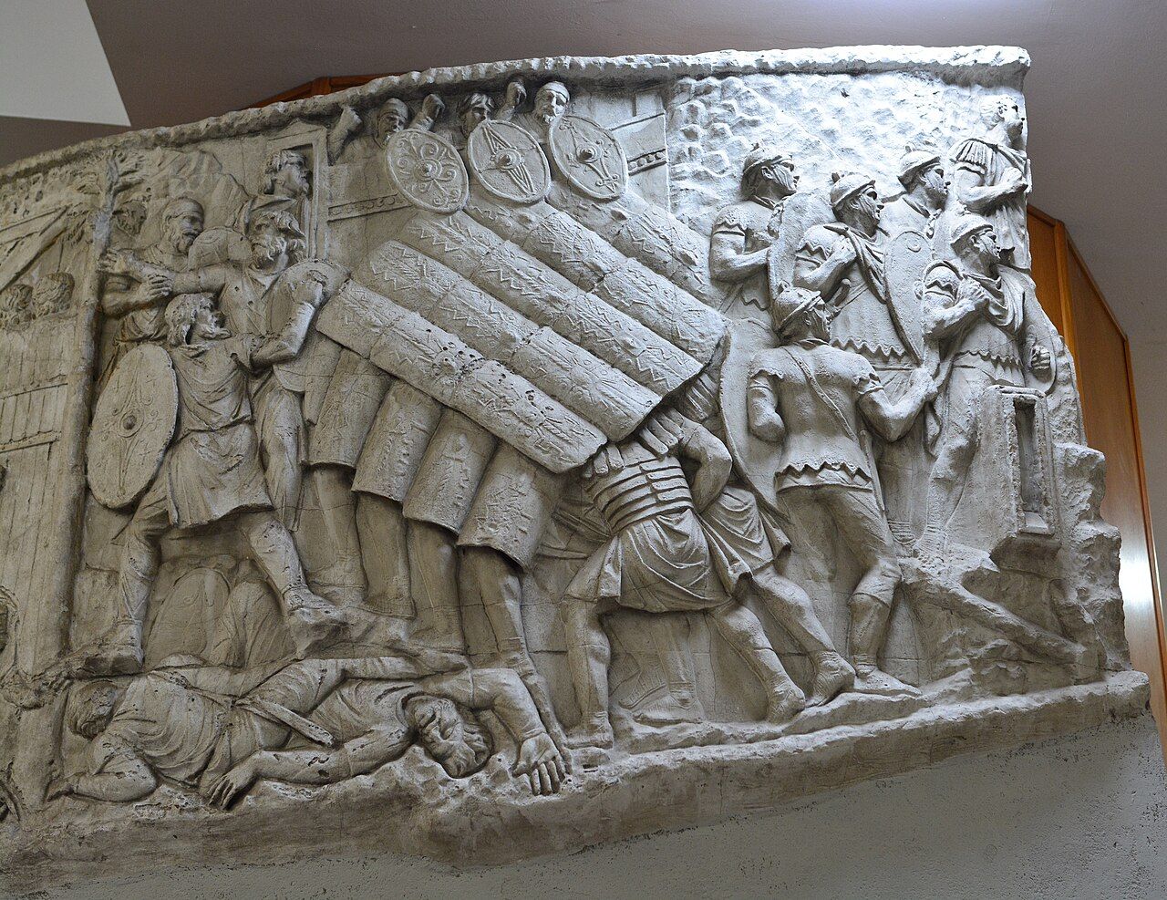 A stone carving of Roman soldiers with shields, from Trajan's Column